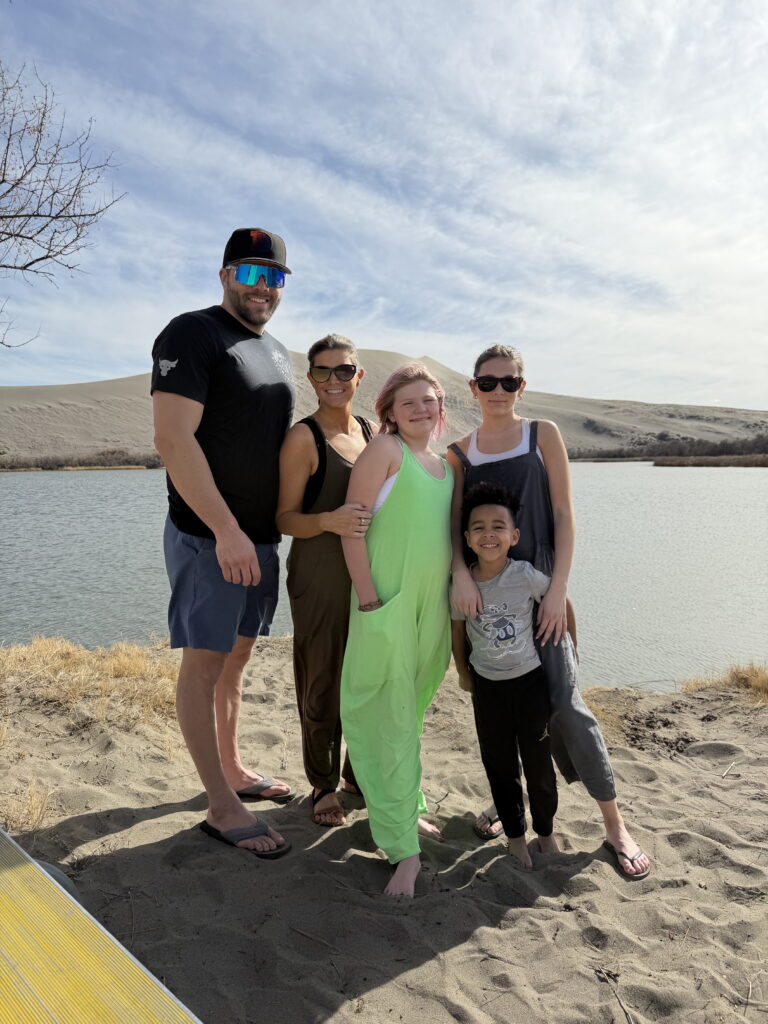 family walking on Bruneau Sand Dunes Idaho with large sand dunes