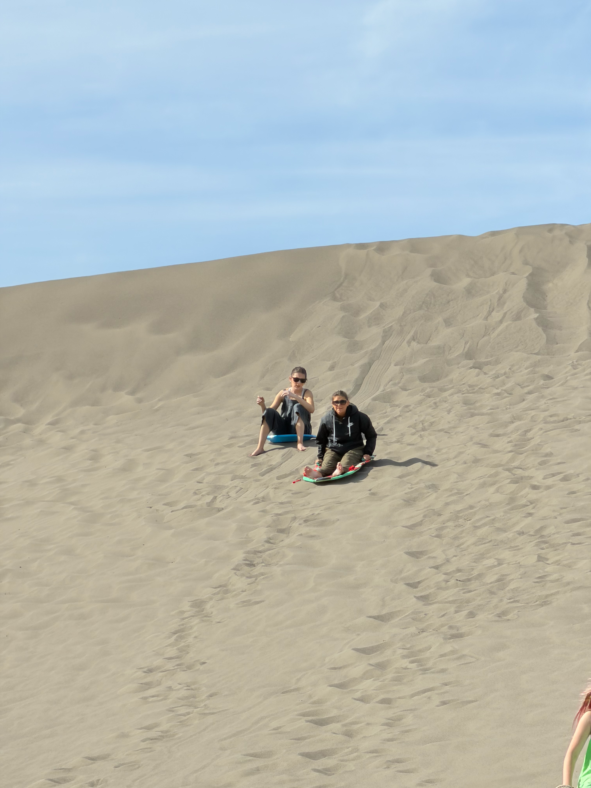 family walking across sand dunes at Bruneau Sand Dunes Idaho
