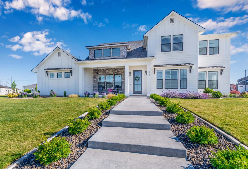 Front exterior of a two-story Treasure Valley home with a landscaped front walkway