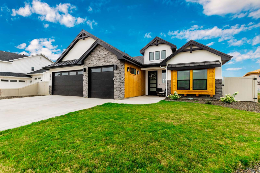 Front exterior of a craftsman-style Treasure Valley home with stone and wood accents