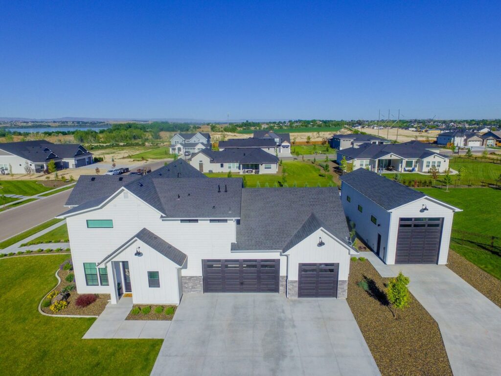 Aerial view of a single-family neighborhood in the Treasure Valley, the kind of streets buyers compare across city lines.